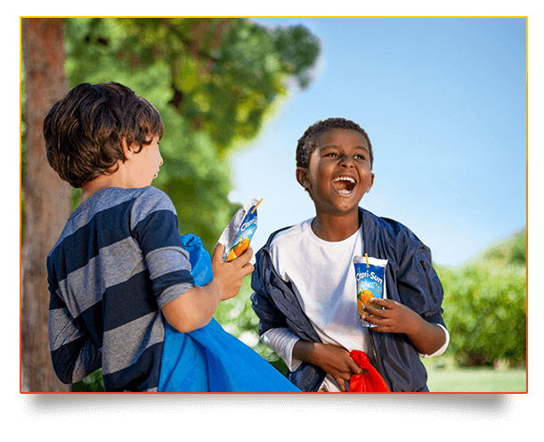 Capri Sun Original Orange two people laughing in park