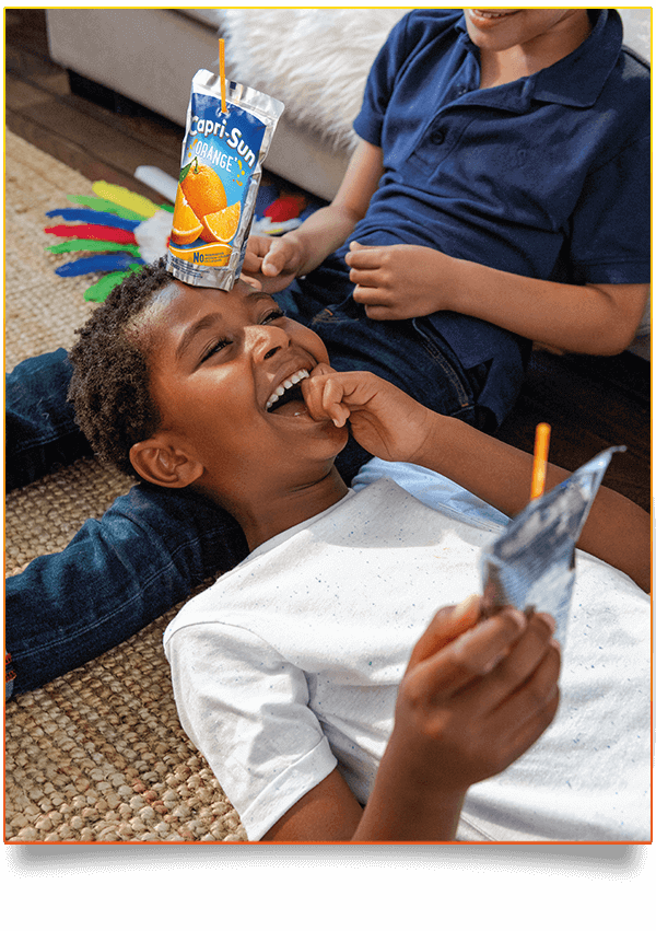 Capri Sun Original Orange two people laughing in livingroom